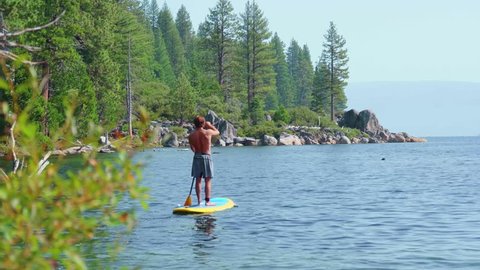 Stand Up Paddle Boarder in Emerald Bay Lake Tahoe Tracking Shot