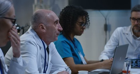 Medium shot of doctors talking during a meeting