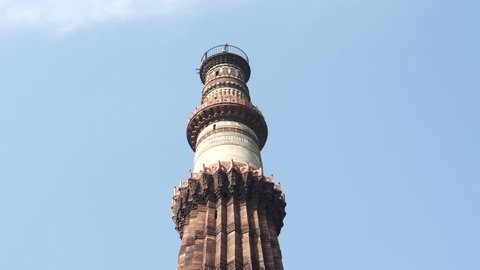 DELHI, INDIA - MARCH 12, 2019: a tilt down clip of the ancient qutub minar tower in new delhi, india