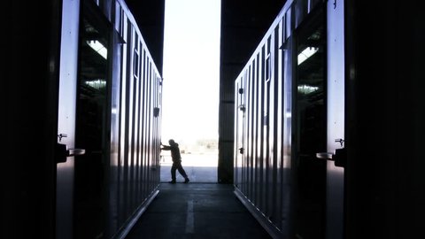 Man Pushing Hangar Metallic Door. 