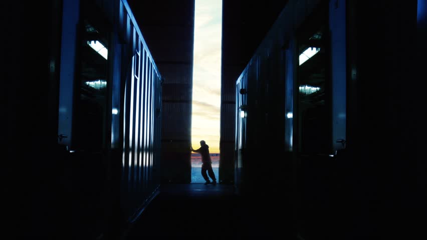 Man pushing Metallic Door in the Factory at Sunset. Concept of Back to Work after COVID-19 Pandemic.  | Shutterstock HD Video #1028582042