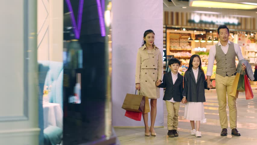 happy asian family with two children walking hand in hand in shopping mall Royalty-Free Stock Footage #1028583098