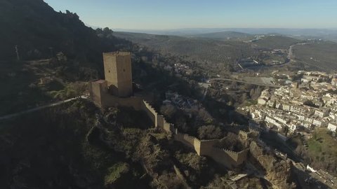 Beautiful aerial shot of Yerda castle (Castillo de la Yerda) in Cazorla, Andalusia, Spain. Cazorla village and olive groves at background
