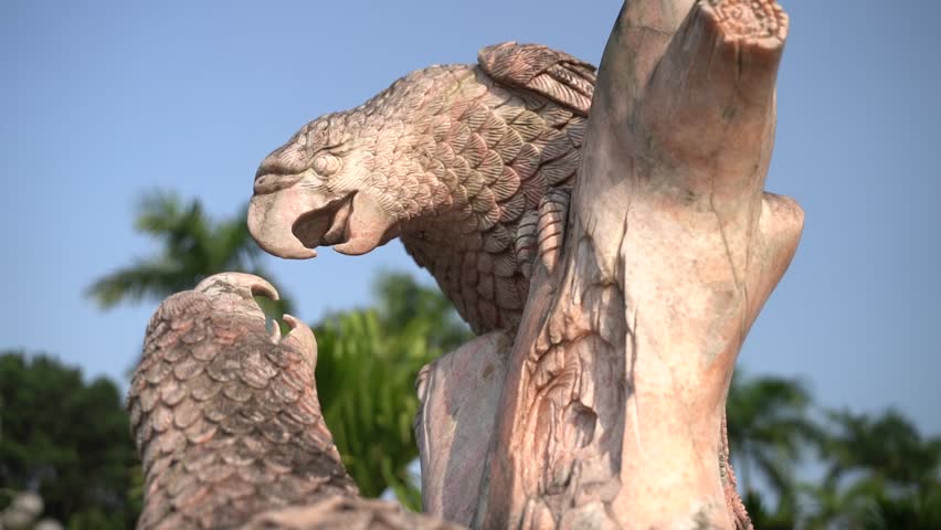 Sculpture of two marble parrots fighting 
