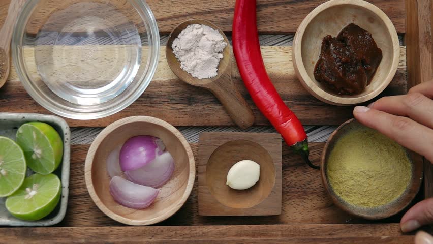Female Hands Taking Nutritional Yeast and Red Onion from Tray. Top View. Vegan and Vegeterian Food. Lifestyle of Health and Sustainability Concept