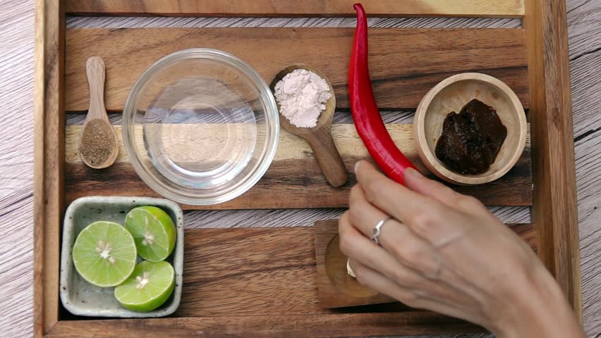 Female Hands Taking Coriander Powder and Pink Himalayan Salt from Tray. Top View. Vegan and Vegeterian Food. Lifestyle of Health and Sustainability Concept