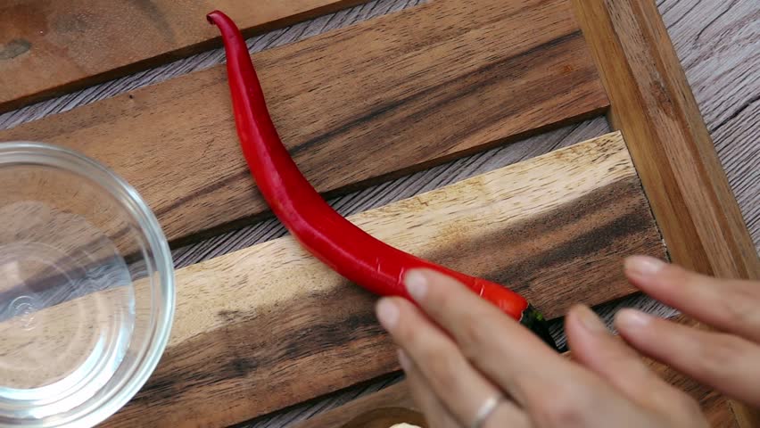 Female Hands Taking Spicy Red Chili Pepper from Tray. Top View. Vegan and Vegeterian Food. Lifestyle of Health and Sustainability Concept