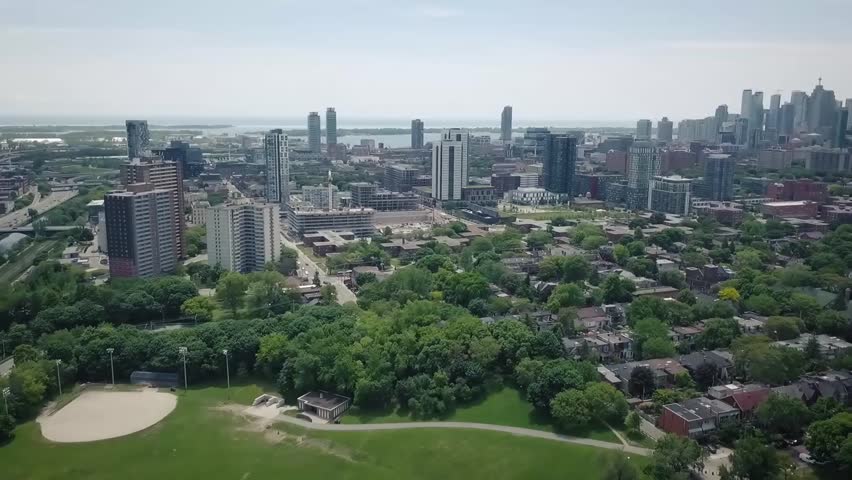 Drone panning over Toronto to reveal city skyline in the distance
