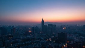 Sunrise over Nanjing city in a sunny day in spring. The video was taken on a rooftop of a tall building.