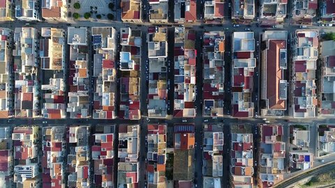 Aerial top down view of building block of Balestrate located in Metropolitan City of Palermo in the Italian region Sicily showing roofs and streets with vehicles driving over 4k high resolution