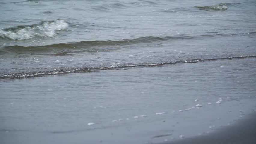 Waves rushing to the beach. Kamakura, Kanagawa, Japan.