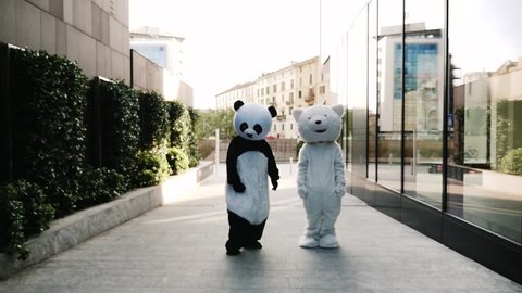 Panda and polar bear dancing in the city to demonstrate and protest against world pollution and animal rights