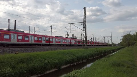 DUSSELDORF, GERMANY - APRIL 24, 2019: Two Deutsche Bahn passenger trains pass the same stretch of track through Dusseldorf, Germany.