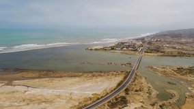 River delta with a bridge of the Panamericana street in South America. Peru. 4K Aerial video footage