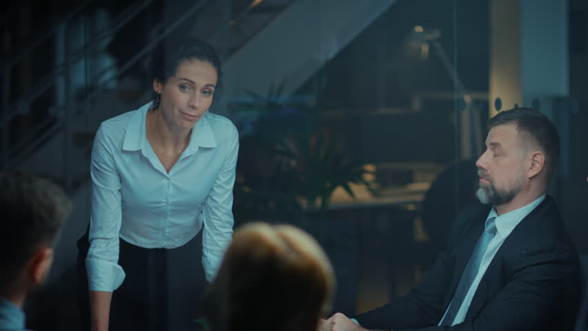 Corporate Meeting Room: Confident and Beautiful Female Executive Director Decisively Leans on the Conference Table and Delivers Report to a Board of Executives about Company’s Record Breaking Revenue Royalty-Free Stock Footage #1028612141