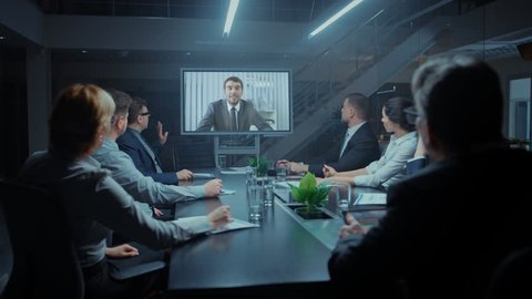 In the Conference Room Group of Directors, Investors and Businessmen Making Late Night Video Conference Call To Talk with International Corporation Representative