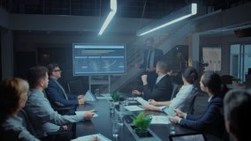 In the Corporate Meeting Room: Male Executive Talks and Uses Digital Interactive Whiteboard for Presentation to a Board of Directors, Investors. Screen Shows Growth Data. Late at Night Office - Powered by Shutterstock - Get 15% off with code: PIKWIZARD15