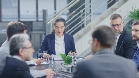 Corporate Meeting Room: Confident Female Executive Director Makes a Report to a Members of the Board and Investors about Company’s Achievement of Record Breaking Annual Revenue Results