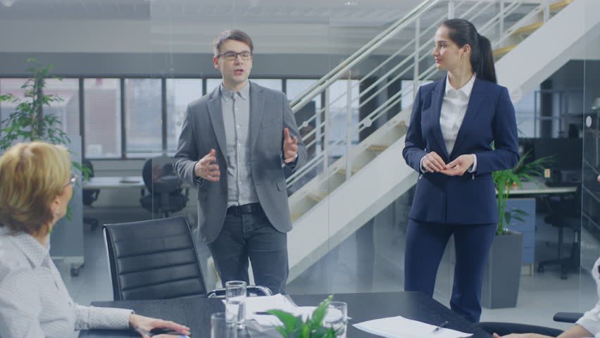 In the Corporate Office Meeting Room: Two Young and Ambitions Start-up Creators Give a Speech to a Group of Venture Capital Investors, Businesspeople Cheer and Applaud in Successful Agreement Royalty-Free Stock Footage #1028612276
