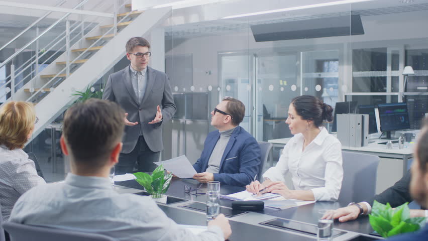 In the Corporate Office Meeting Room: Chief Technology Analyst Talks to a Board of Directors and Executives about the Need for the Company to Create Modern Vision and Competitive Market Strategy | Shutterstock HD Video #1028612288