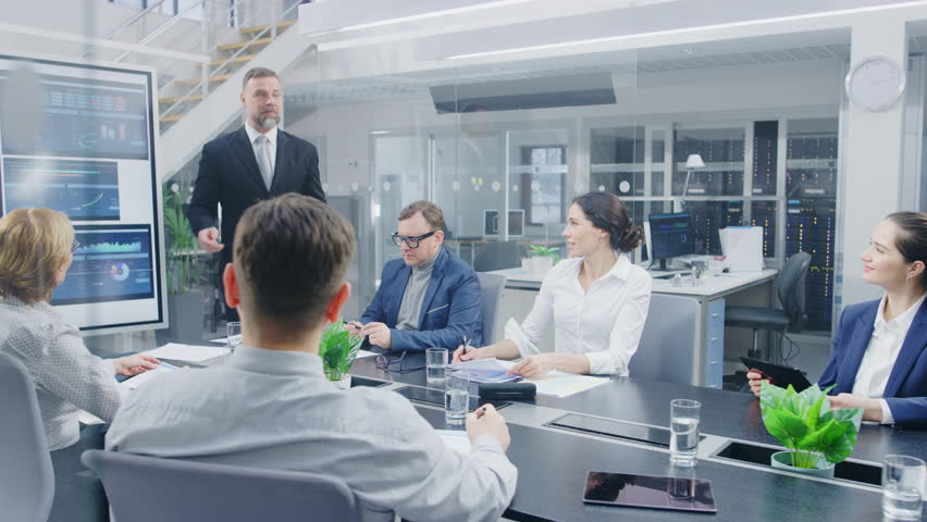 In the Corporate Meeting Room: Enthusiastic Director Uses Digital Interactive Whiteboard for Presentation and Delivers Powerful Speech to a Board of Executives. Everybody Cheers and Applauds | Shutterstock HD Video #1028612291
