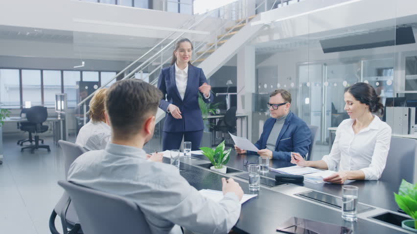 Corporate Meeting Room: Young and Ambitious Female Executive Director Delivers Powerful Speech About Company’s Achievement of Record-Breaking Annual Revenue Results to a Board of Executives, Investors | Shutterstock HD Video #1028612300