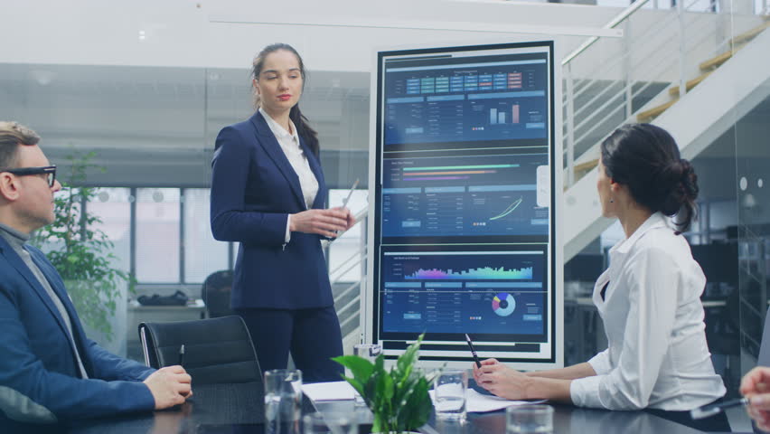 In the Corporate Meeting Room: Young and Ambitious Female Executive Uses Digital Interactive Whiteboard for Presentation and Delivers Passionate Speech to a Board of Executives, Lawyers, Investors | Shutterstock HD Video #1028612369