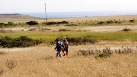 Couple Walking Through Fields in Big Sur
