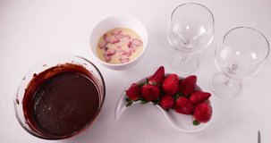 Speed up clip of Lady cutting strawberries into a white bowl with condensed milk and cream mixture to prepare a pave french dessert recipe 4k 30 fps