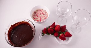 Speed up clip of Lady pouring a mixture of condensed milk, cream, and strawberries into a glass to prepare a pave french dessert recipe 4K 30 fps