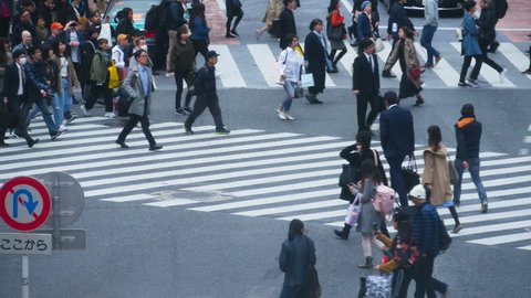 TOKYO , JAPAN - March 25, 2019: crowds of people walking across at Shibuya famous crossing street in Tokyo, Japan