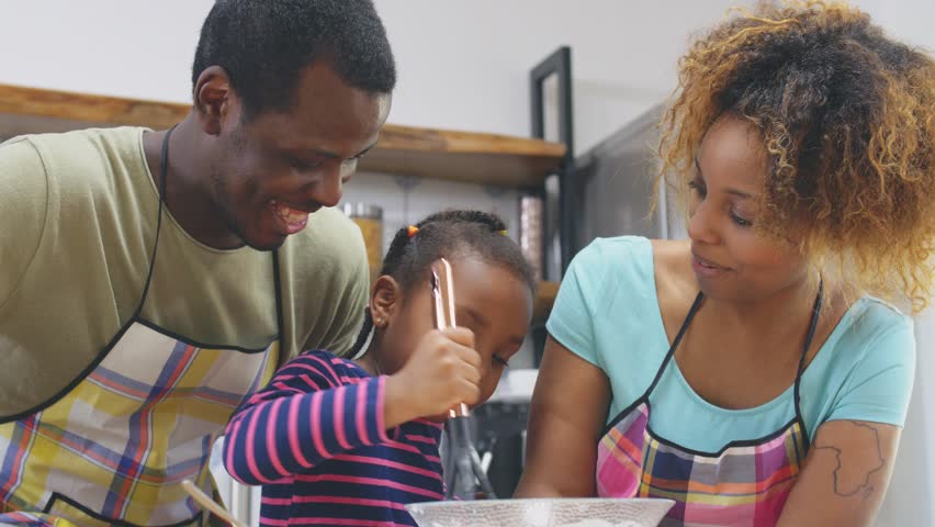 Close up of funny African family in kitchen cooking and tasting dough Royalty-Free Stock Footage #1028621525