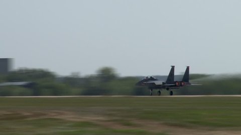 Zhukovsky, Russia, August 18, 2011. Fighter F-15 Eagle accelerates on runway and takes off almost vertically. Dark gray plane quickly picks up speed. Takeoff distance shortened.