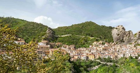 Castelmezzano village in Basilicata region of Italy. Town in dolomiti lucane opposite to pietrapertosa town. Time lapse video in a sunny day with blue sky and fluffy clouds