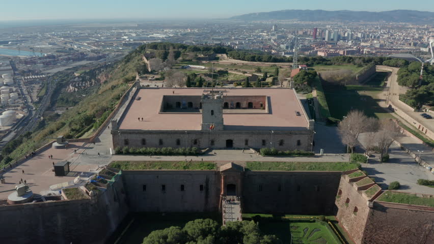 25P flying over Montjuic Castle towards view of Barcelona