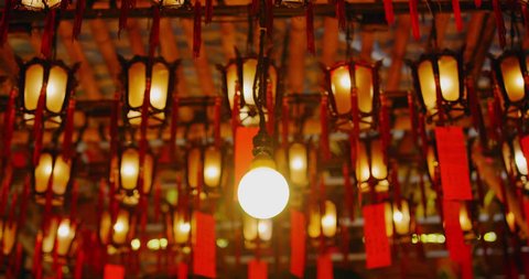 Close up of lights and lanterns Burning Buddhist Temple Religious Mysterious Beautiful in Hong kong China Asia. Slow motion, shot on red camera. Note: No Visible faces / people