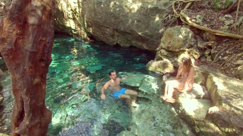 Guy Swimming in a Cenotes in Tulum