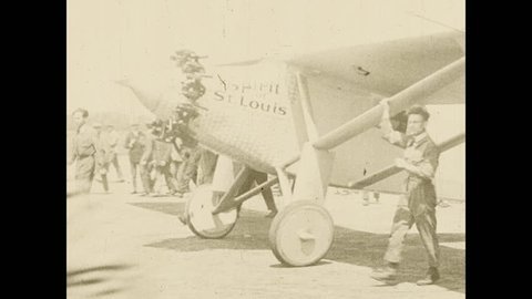 1920s: The Spirit of St. Louis plane is pushed out on to the runway and takes off into the air.