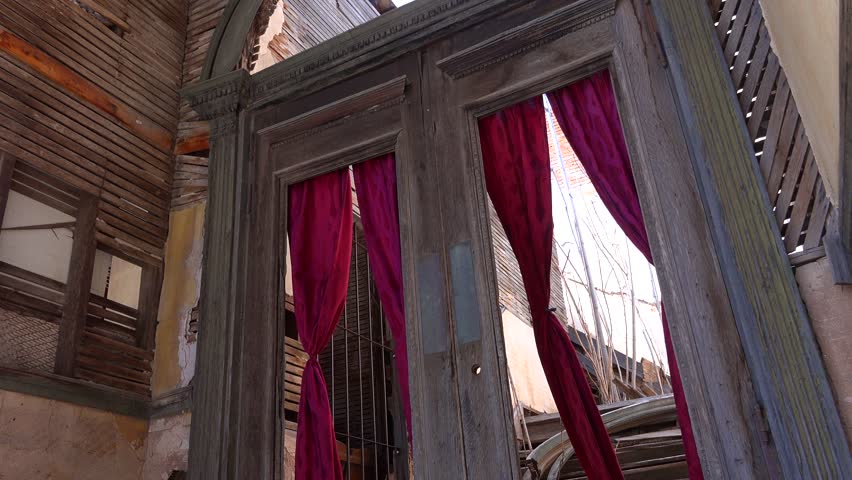 Spooky doors with wind blowing drapes in Jerome Arizona.