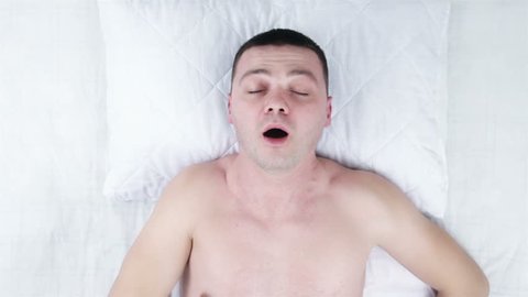 High angle view of a man masturbating in bed