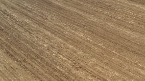 Flying over ploughed fertile soil 4K aerial video