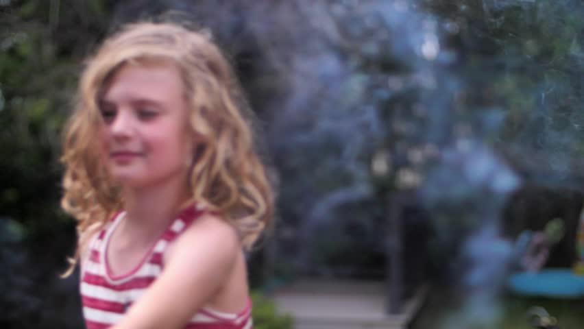 Girl plays with sparkler in slow motion