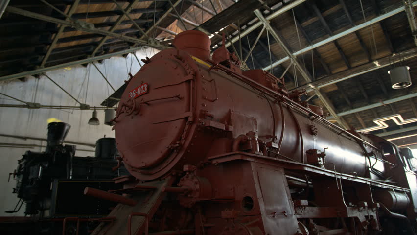 Big old locomotive in an warehouse with disco lights in the background