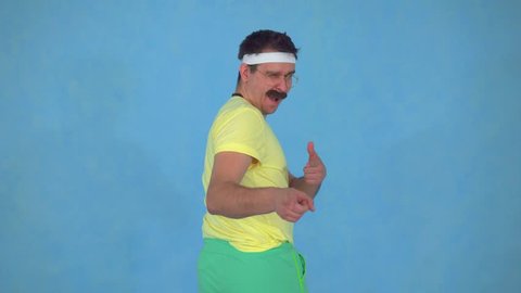 Portrait of funny man trainer with a mustache from the 80's on a blue background