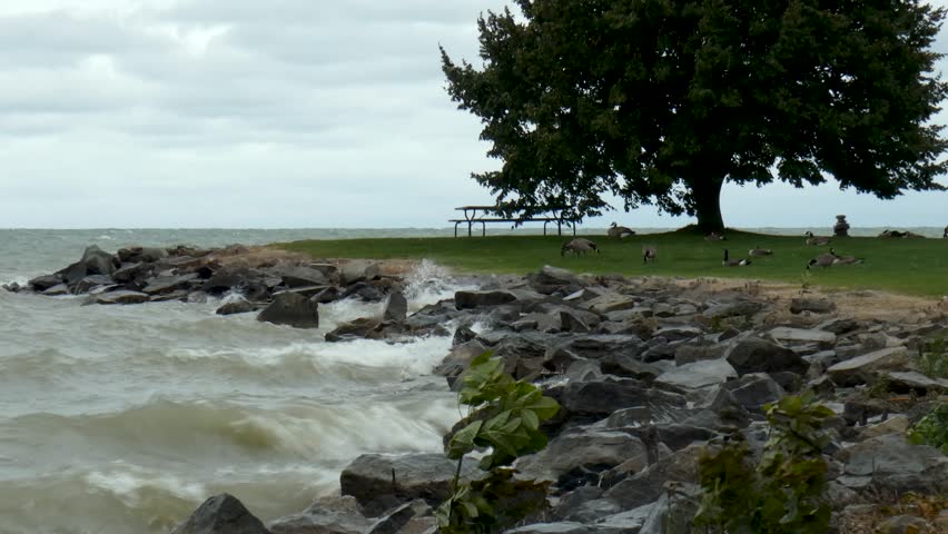 Waves crash upon a rocky shoreline.