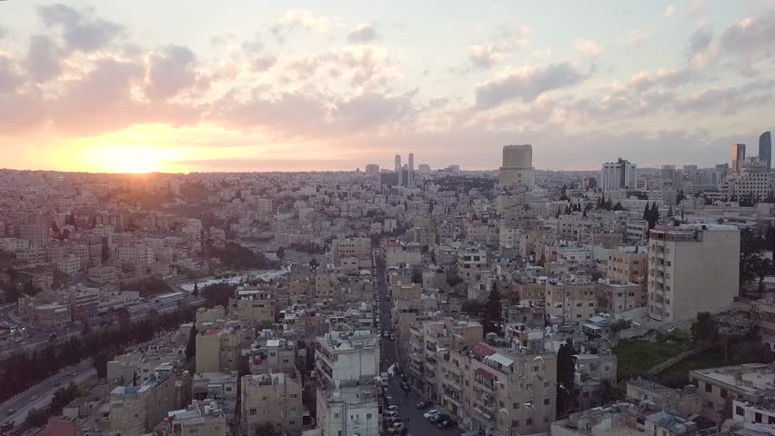 Beautiful peaceful aerial clip of early morning at Amman City Jordan taken by a drone with horizon breaking into pink and yellow hues of a rising sun | Shutterstock HD Video #1028690714
