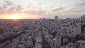 Beautiful peaceful aerial clip of early morning at Amman City Jordan taken by a drone with horizon breaking into pink and yellow hues of a rising sun