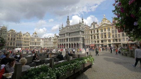 Belgium, Brussels - October, 2016: Tourists relaxing at a restaurant and walking in Grand Place, Brussels
