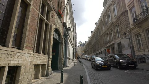 Belgium, Brussels - October, 2016: Buildings and parked cars on a cobblestone street