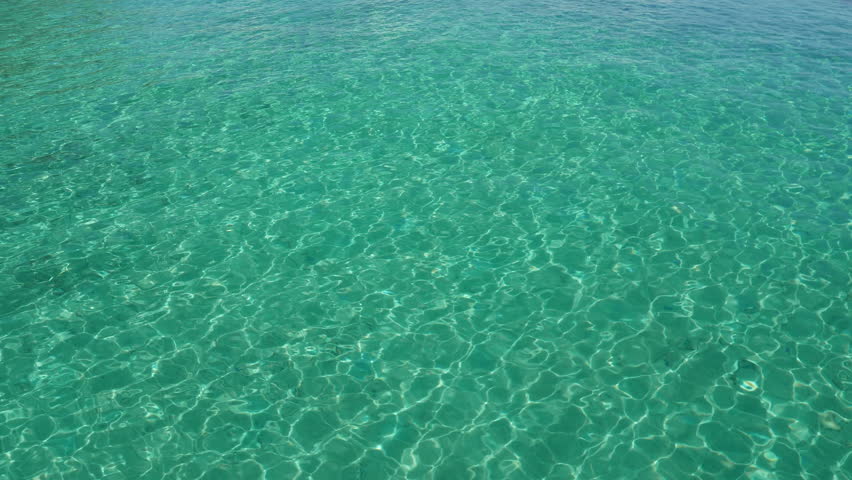 Bright Blue seawater ripples and relfects light off of it's surface in a tropical paradise.